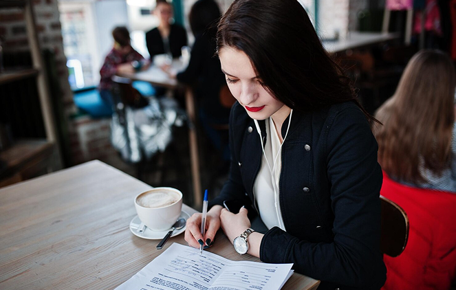 Employee reviewing a work reference letter outlining job duties and employment details for Canadian immigration